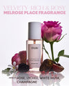OUAI Melrose Place fragrance bottle with pink rose and berries on a white background