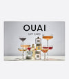 OUAI Gift Card featuring perfume bottles and elegant cocktail glasses on display.