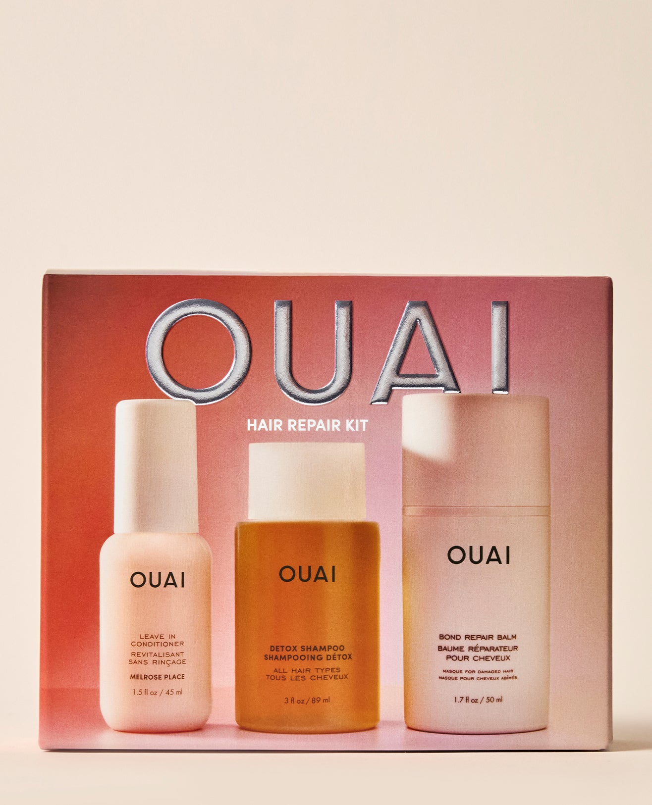 OUAI Hair Repair Kit containing three bottles: Medusa Shine Leave-In Conditioner, Detox Shampoo, and Bond Repair Hair Enhancer, displayed in front of their pink packaging box.