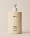 A large ivory OUAI Fine Hair Conditioner pump bottle stands upright against a softly lit cream background. Text: “OUAI”, “FINE HAIR”, “CHEVEUX FINS”, “CONDITIONER”, “REVITALISANT”, “16 fl oz / 474 ml”.