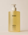 A jumbo translucent OUAI Fine Hair Shampoo pump bottle containing pale yellow liquid stands against a warm cream background. Text: “OUAI”, “FINE HAIR”, “CHEVEUX FINS”, “SHAMPOO”, “SHAMPOOING”, “16 fl oz / 474 ml”.