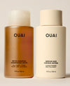 Two OUAI hair care bottles on a light beige background: a translucent amber bottle of detox shampoo on the left and a matte cream bottle of conditioner on the right.